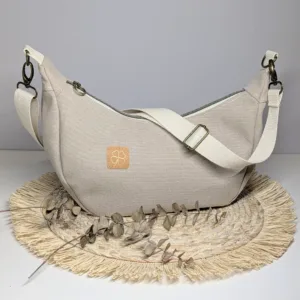 Sac à main demi lune toile beige. Couleur tendance été. Pratique.